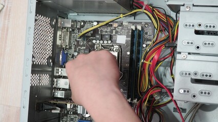 technician hold the screwdriver for repairing the laptop. computer hardware, repairing, upgrade and...