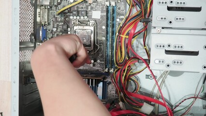 technician hold the screwdriver for repairing the laptop. computer hardware, repairing, upgrade and...