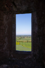Fototapeta premium old castle window with view of fields