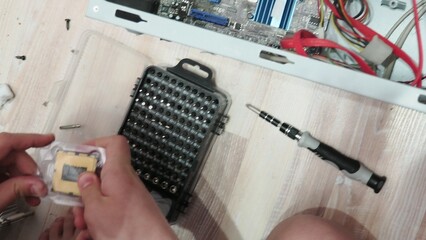 technician hold the screwdriver for repairing the laptop. computer hardware, repairing, upgrade and...