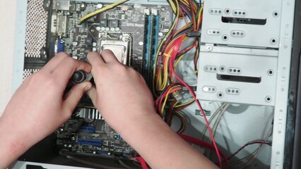 technician hold the screwdriver for repairing the laptop. computer hardware, repairing, upgrade and...