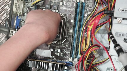 technician hold the screwdriver for repairing the laptop. computer hardware, repairing, upgrade and...