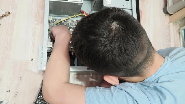 technician hold the screwdriver for repairing the laptop. computer hardware, repairing, upgrade and technology. professional technicial at workplace concentrated. focus on hands