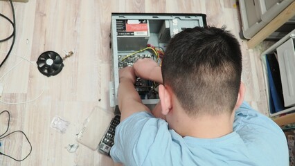 technician hold the screwdriver for repairing the laptop. computer hardware, repairing, upgrade and technology. professional technicial at workplace concentrated. focus on hands