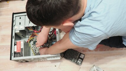 technician hold the screwdriver for repairing the laptop. computer hardware, repairing, upgrade and technology. professional technicial at workplace concentrated. focus on hands