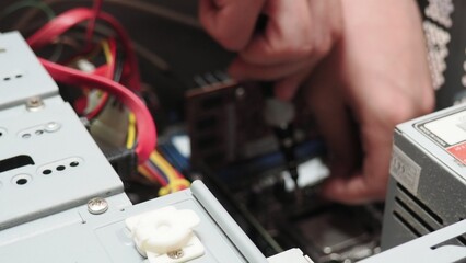 technician hold the screwdriver for repairing the laptop. computer hardware, repairing, upgrade and technology. professional technicial at workplace concentrated. focus on hands