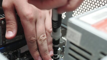 technician hold the screwdriver for repairing the laptop. computer hardware, repairing, upgrade and technology. professional technicial at workplace concentrated. focus on hands