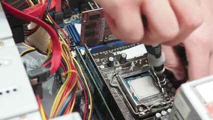 technician hold the screwdriver for repairing the laptop. computer hardware, repairing, upgrade and technology. professional technicial at workplace concentrated. focus on hands