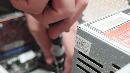 technician hold the screwdriver for repairing the laptop. computer hardware, repairing, upgrade and technology. professional technicial at workplace concentrated. focus on hands