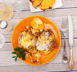 Tasty french style meat with side dish of fried potato closeup
