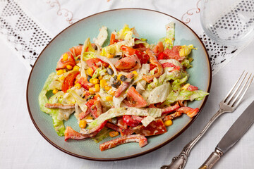 In center of plate is small portion of vegetable salad of pim , corn, cabbage, mayonnaise.