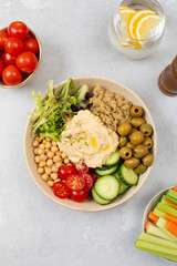 Top view of colorful Buddha bowl with quinoa, hummus, chickpeas, vegetables. Healthy vegetarian dish