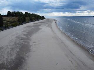 Seaside Serenity: A tranquil coastal vista unfolds, featuring a sandy beach meeting the gentle...