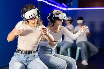 Couple of girls face off against couple of guys during helmet game. Participants enthusiastically...