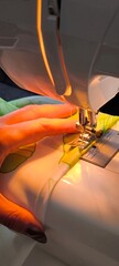 Seamstress at work: close-up of sewing on a sewing machine