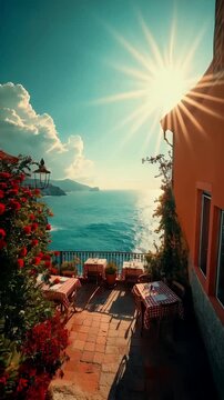 Sunlit Seaside Terrace with Red Flowers and Checkered Tables

