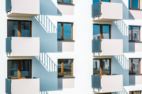 Modern apartment building facade with repetitive balconies and shadow play