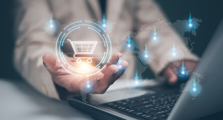 E-commerce concept. Man use laptop and holding shopping cart icon with map for worldwide product...