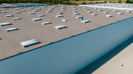 Aerial view of industrial warehouse roof with skylights and ventilation domes