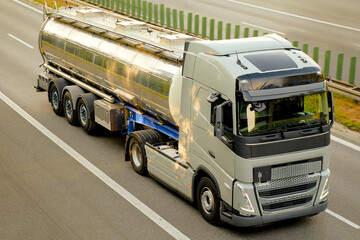 Modern Sustainable Shiny Stainless Steel Road Tanker Truck Transporting Liquid Cargo on Expressway