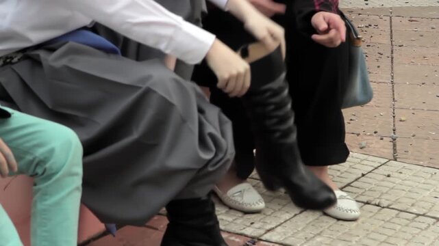 Argentine Mother Helping Son Dress for Chacarera With Traditional Outfit - Low Angle View
