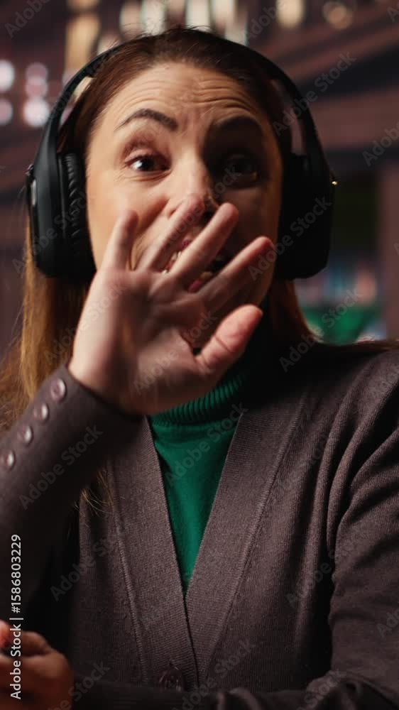 Poster vertical video pov of focused woman sits in a campus library on a video call for a seminar, attendin