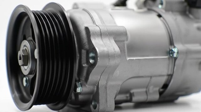 Gray Car Ac Compressor Close Up View With Black Pulley On White Background