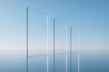 Three translucent glass panels stand in a row on a reflective surface against a clear blue sky background