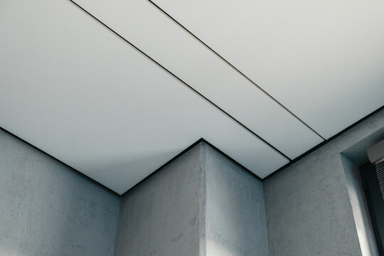 Minimalist modern ceiling with concrete and acoustic panels in interior