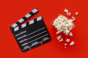 Striped box with popcorn and clapperboard on a red background