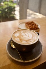 cup of cappuccino and baked good