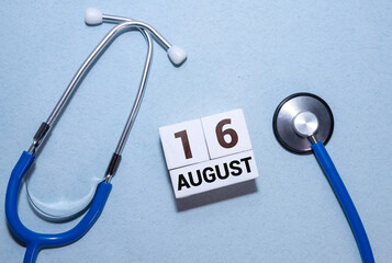 August 16th. Image of august 16 wooden color calendar on blue background. Summer day.