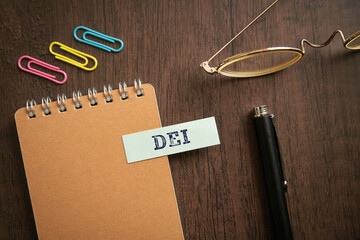 There is sticky note with the word DEI. It is an abbreviation for Diversity, Equity, Inclusion as...