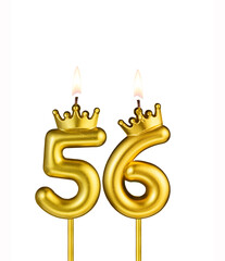 Golden number 56 birthday candle on white background