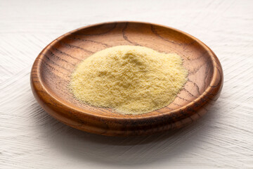 Wheat semolina in a wooden bowl - Triticum
