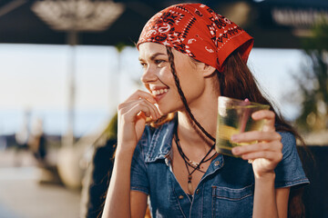 Lifestyle woman smiling in modern boho-western denim street style wearing red bandana, enjoying...