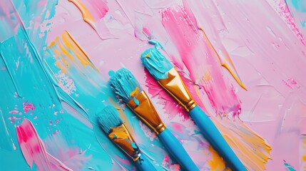 Top view of paintbrushes and mixed paint, bright colors and texture forming a dynamic creative composition