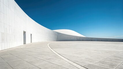 Modern white architecture with curved walls under a clear blue sky