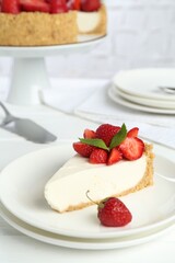 Piece of tasty cheesecake with strawberries and mint on white table, closeup