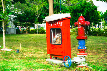 A red fire hydrant and a matching cabinet displaying 