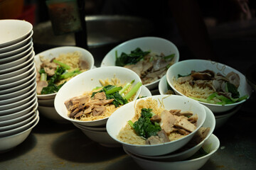 thai noodle soup, Egg noodles with sweet pork and boiled vegetables, street food at  Yaowarat, China Town Thailand. 