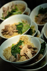 Egg noodles with sweet pork and boiled vegetables, street food at  Yaowarat, China Town Thailand. 