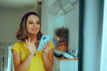 Woman Sets Air Conditioning with Phone App. Person making her home comfortable using remote...