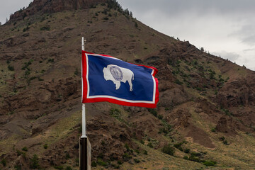 State of Wyoming flag against of rock formations