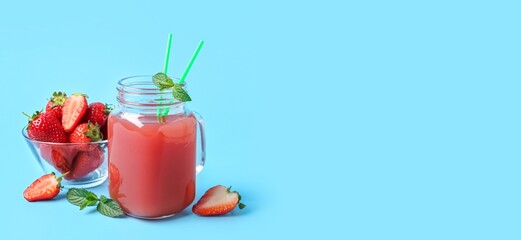 Mason jar of tasty strawberry juice on light blue background with space for text