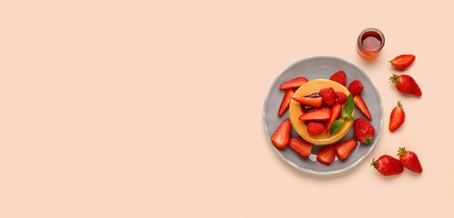 Plate of sweet pancakes, berries and jam on beige background with space for text, top view