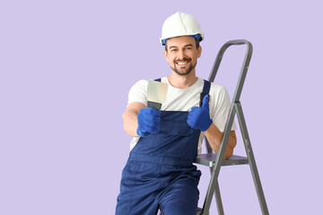 Male decorator with putty knife and stepladder on lilac background
