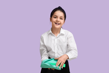 Little schoolgirl with pencil case on lilac background