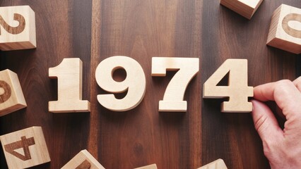 The Year "1974" in Wooden Blocks Retro Numbers Design on Vintage Wooden Table