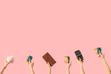 Women with credit cards, piggy bank, wallet and payment terminal on pink background